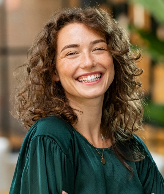 Woman smiling confidently after cosmetic dentistry treatment at TRU Dentistry SoCo in South Austin, TX