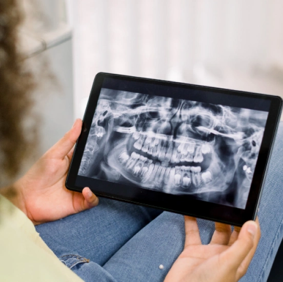 Patient viewing a digital panoramic dental X-ray on a tablet at TRU Dentistry SoCo in South Austin, TX