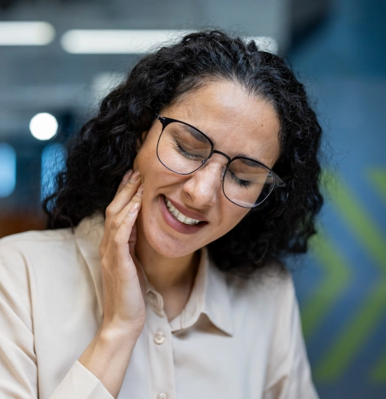 Woman experiencing jaw pain in need of TMJ treatment at TRU Dentistry SoCo in South Austin, TX