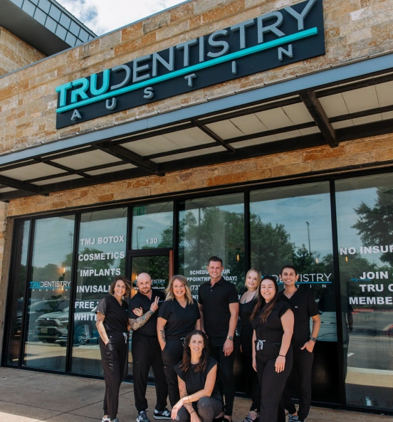 Dental team standing outside the office storefront at TRU Dentistry SoCo in South Austin, TX